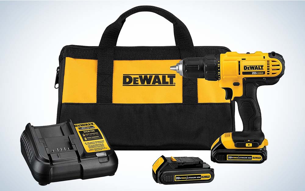 A yellow and black DeWalt Cordless Drill and Driver in front of a DeWalt bag and next to a battery charger.