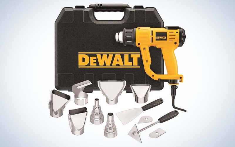 A yellow and black DeWalt heat gun in front of a black DeWalt bag with silver attachments in the foreground.